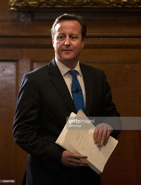 prime minister david cameron arrives holding his notes before making news photo getty images