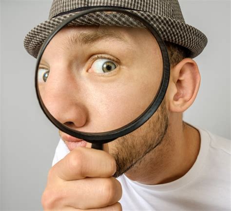 Premium Photo | Astonished man looking through a magnifying glass