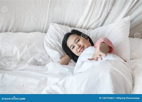 closeup asian woman lie on bed with invite someone motion in the morning stock image image of