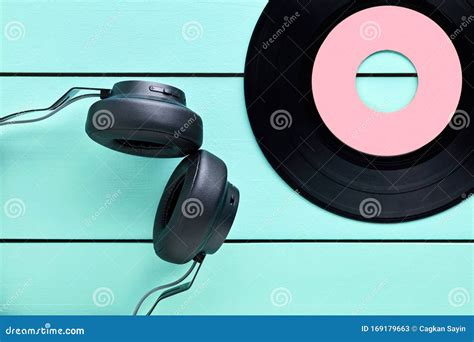 Vinyl Record And A Headphone On Turquoise Wooden Background Stock Image