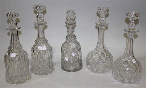 A Pair Of Cut Glass Decanters And Stoppers Of Bell Shaped Form With Cut And Polished Decoration Tog