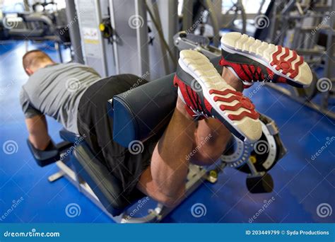 Man Flexing Leg Muscles On Gym Machine Stock Image Image Of Healthy