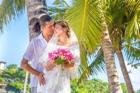 Bride And Groom Holding Bridal Bouquet On Natural Sea Background Stock Image Image Of