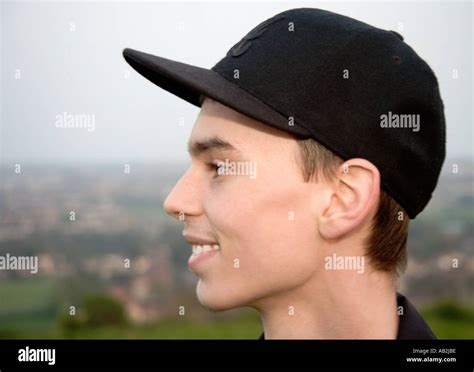 Young Man Wearing Baseball Cap Smiling Portrait Side View Close Up