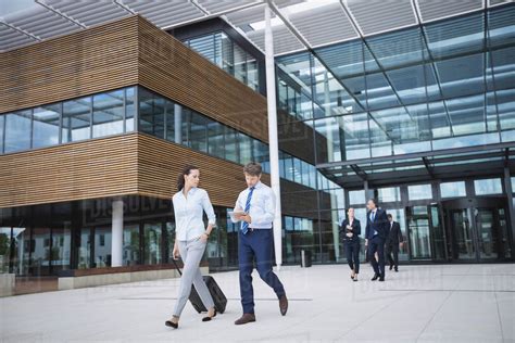 Group Of Business People Walking Outside The Entrance Of An Office