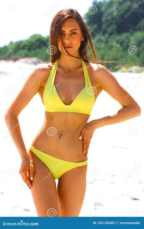 Young Beautiful Sporty And Woman In Yellow Bikini Posing On The Beach Stock Image Image Of