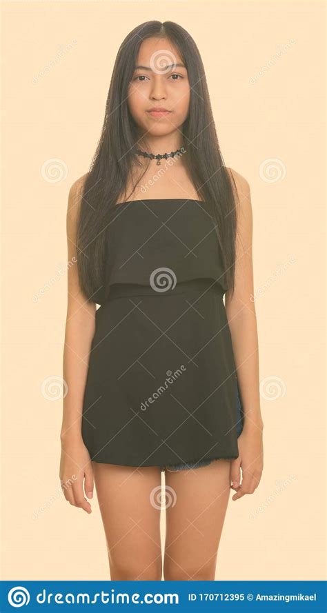 Portrait Of Young Beautiful Asian Teenage Girl Standing Stock Image