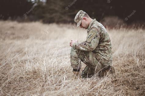 Premium Photo Shallow Focus Shot Of A Young Soldier Praying While