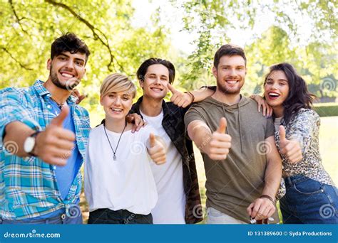 Happy Smiling Friends Showing Thumbs Up At Park Stock Photo Image Of