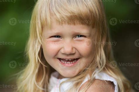 Happy Little Blonde Girl Cheerfully Smiles 3512843 Stock Photo At Vecteezy