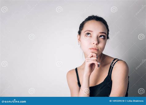 Portrait Of An Attractive Thoughtful Young Brunette Woman Stock Photo
