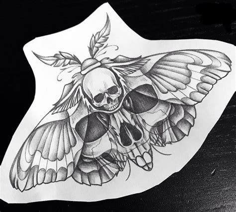 A Sticker With A Skull And Butterfly On Its Back Side Sitting On Top