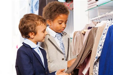 Two Male Friends Choosing Clothes In The Store Stock Photo Image Of