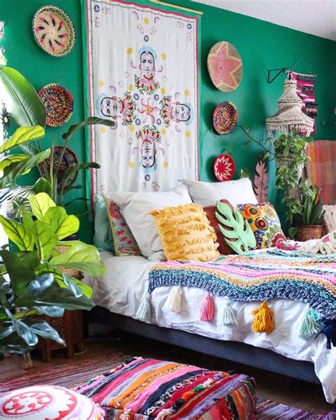 A Bedroom With Green Walls And Lots Of Colorful Decorations On The Wall Above The Bed