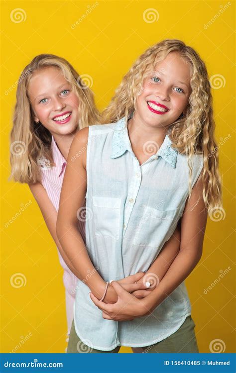 Happy Beautiful Twins Sisters With Blonde Wavy Hair Amazing Eyes