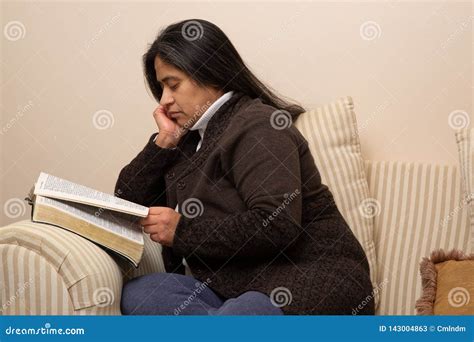 hispanic woman reads bible on couch stock image image of christianity mediation 143004863
