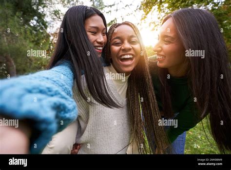 Portrait Of Three Girls Outside Having Fun Taking Selfie Friendship In