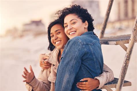 couple lgbtq hug and smile on beach together for relax interracial portrait on travel vacation