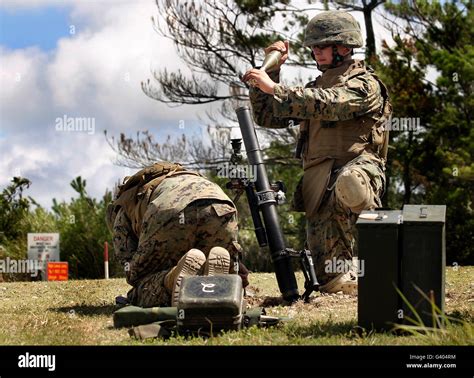 A Soldier Loads A High Explosive Mortar Round Into An M 224 60 Mm