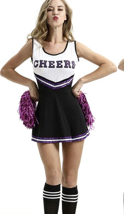 A Cheerleader Is Posing For The Camera With Her Hands On Her Hips