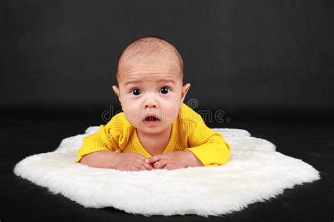 Surprised And Curious Baby Boy Lying On White Fur Stock Photo Image