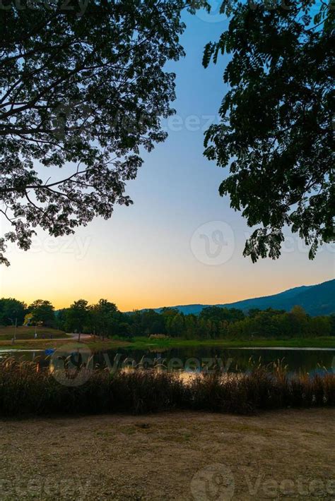 Beautiful Lake At Chiang Mai With Forested Mountain And Twilight Sky In