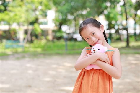Premium Photo Adorable Little Asian Child Girl Hugging Teddy Bear