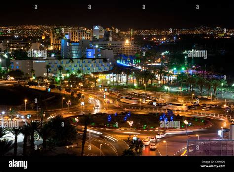 A View Of The Hotel And Beach Area Of Eilat At Night With The Lights Of