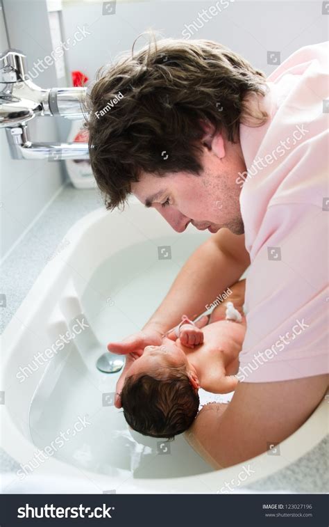 The fever shows the baby's body is responding to the. Young Father Bathing His Newborn Baby In The Hospital Just ...