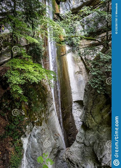 Vertical Shot Of A Babbling Waterfall Through Mossy Rocks Stock Image