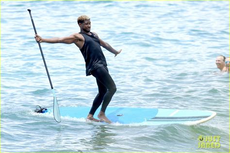 Full Sized Photo Of Usher Stays Clothed While Paddle Boarding Goes