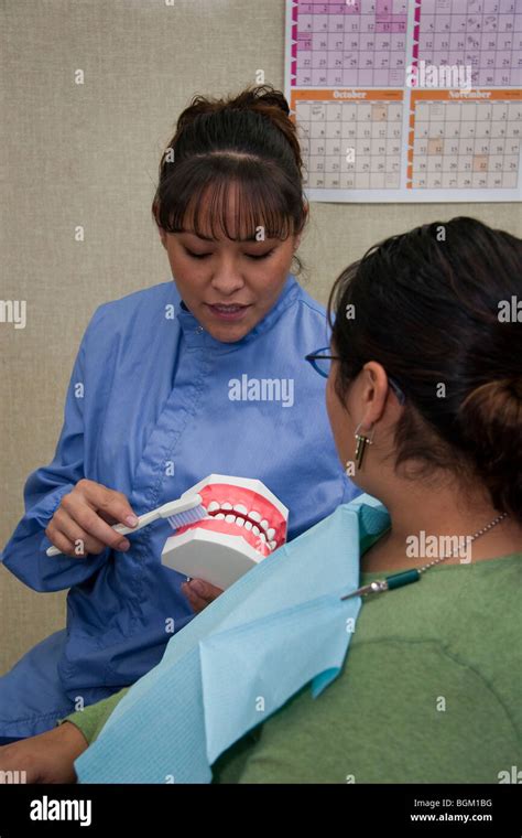 Native American Dental Hygenist Demonstrates Proper Teeth Brushing And