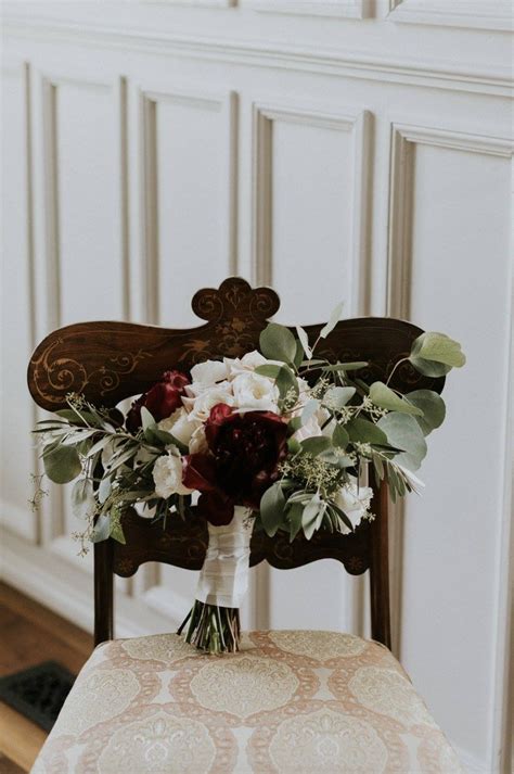 A Bouquet Of Flowers Sitting On Top Of A Wooden Chair