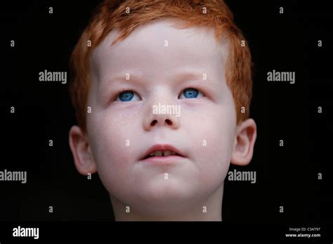 A 7 Year Old Boy Stares Black Background Stock Photo Alamy