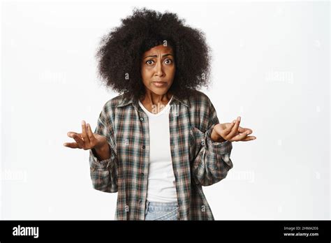 Image Of Confused And Worried Black Woman Asking Question Shrugging