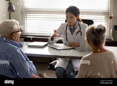 Female Doctor Consult Old Couple Patients In Hospital Stock Photo Alamy