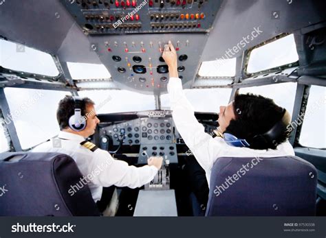 Pilots Inside A Cabin Flying An Airplane Stock Photo 97530338