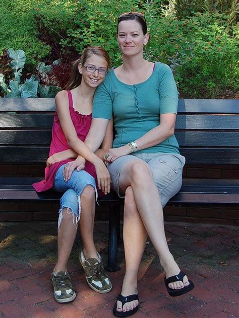 Two Women Are Sitting On A Bench Together