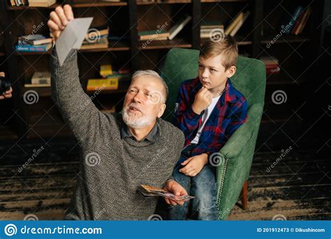 Caucasian Cheerful Gray Haired Grandfather With Grandson Enjoy Memories