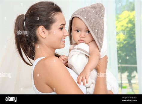 Mother Holding Cute Baby In Towel After Bathing At Home Stock Photo Alamy