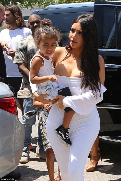 Kim Kardashian Wears Incredibly Low Cut Corset Top And White Leggings