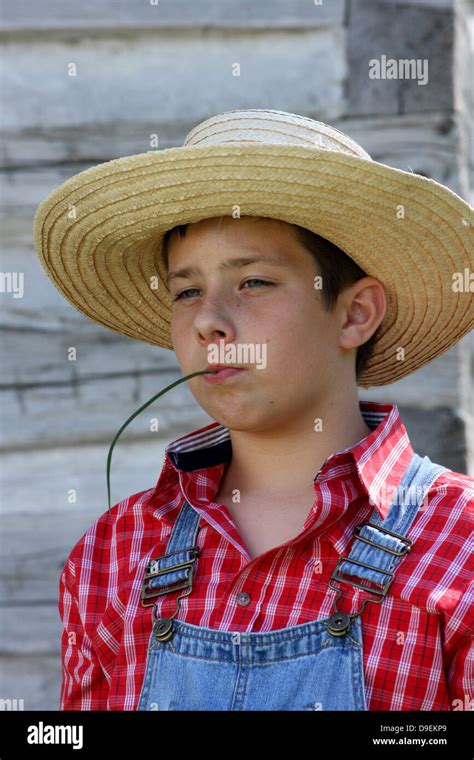 A Farmer Boy Chewing On A Blade Of Grass Stock Photo Alamy