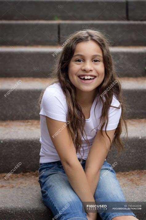 Portrait Of Cute Girl Sitting On Stairs Outside — One Person Stock