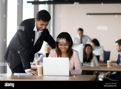Cheerful Diverse Coworkers Working Together In Coworking Area Stock
