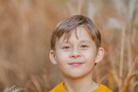 Cute Little Boy 7 Years Old Plays In The Autumn Bright Park Portrait