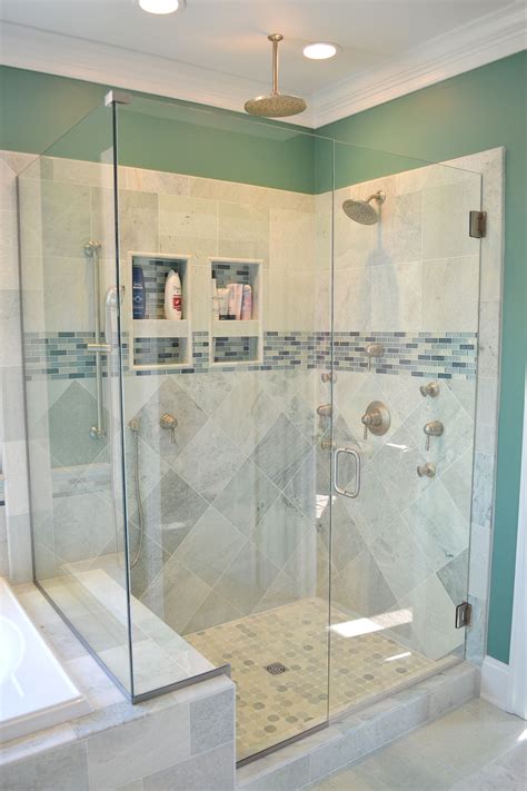 Beautiful Walk In Shower With Gray Tiles And A Blue Accent To