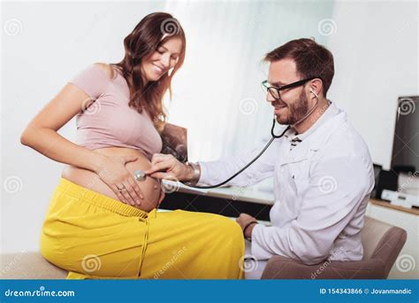 Gynecologist Doctor And Pregnant Woman Meeting At Hospital Stock Photo