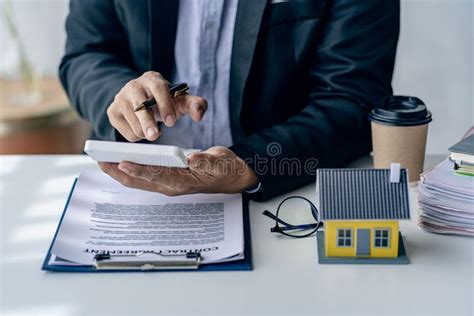 Real Estate Agent Or Bank Officer Working With Paperwork And Laptop
