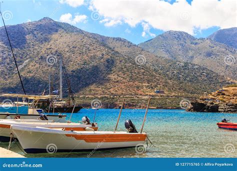 Small Fishing Boats At Pier In Fishing Village Bali With Mountains At