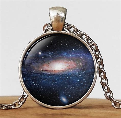 An Image Of The Andromidus Galaxy Pendant On A Chain